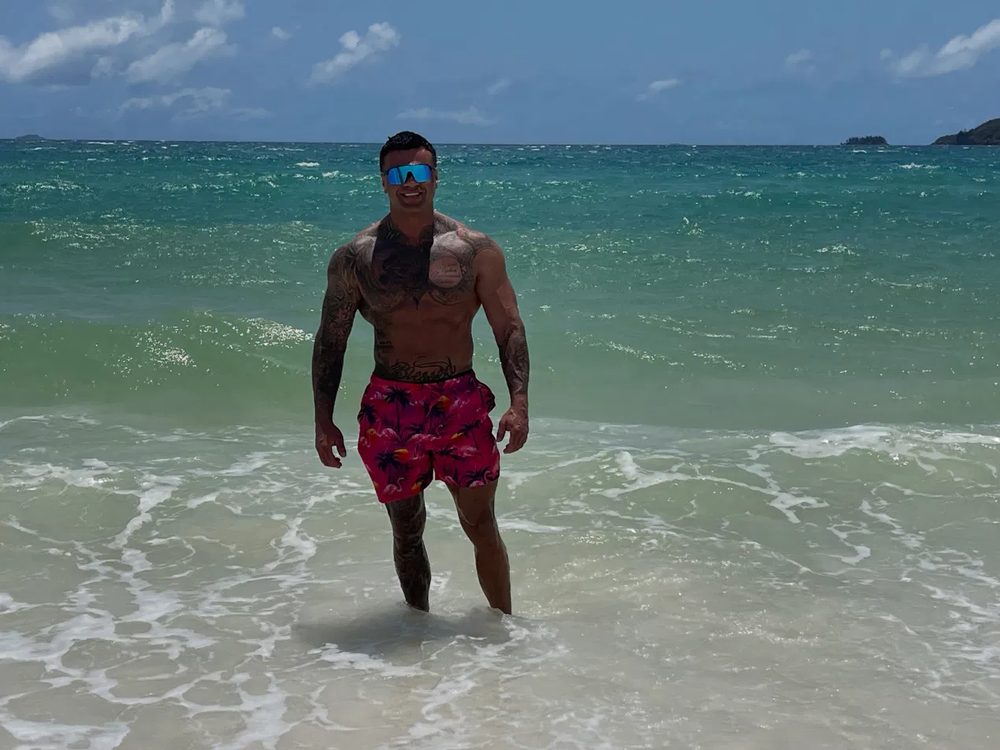 Dave Augustyniak standing in the sea on a beach